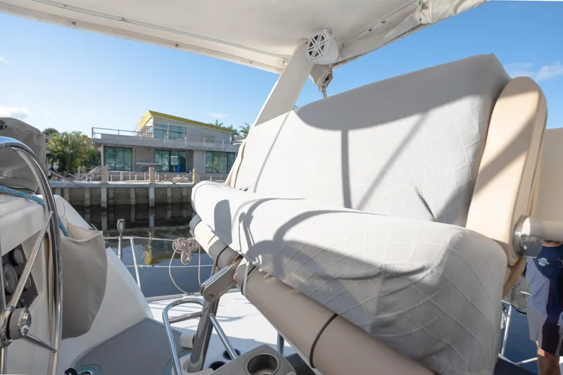  Yacht Photos Pics Leopard 46 yacht interior with cushioned seating, docked near modern waterfront building.