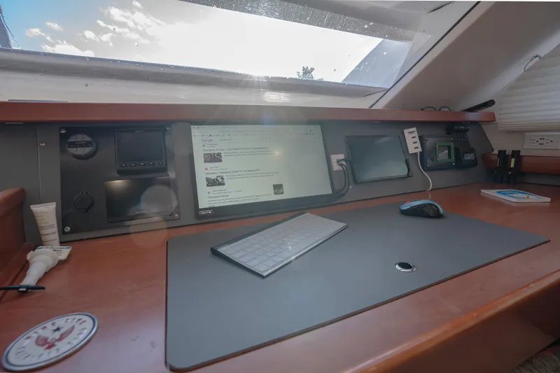  Yacht Photos Pics Navigation station inside a 2011 Leopard 46 yacht, featuring a keyboard, mouse, and electronic displays.