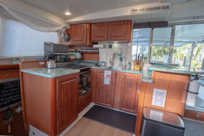  Yacht Photos Pics Cozy kitchen interior of 2011 Leopard 46 yacht with wooden cabinets and modern appliances.