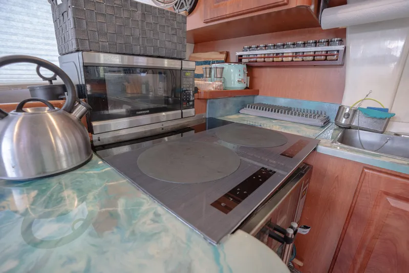  Yacht Photos Pics Modern kitchen in a 2011 Leopard 46 yacht with stove, kettle, and spice rack.
