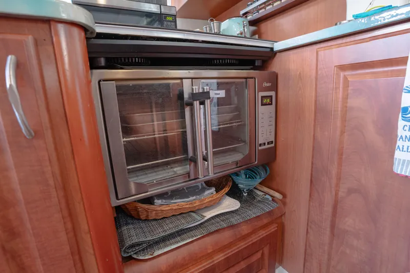  Yacht Photos Pics Microwave oven in a Leopard 46 yacht kitchen, 2011 model, with wooden cabinetry.