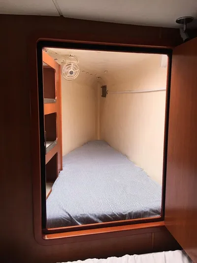  Yacht Photos Pics Compact cabin bed with striped bedding in 2011 Leopard 46 yacht.