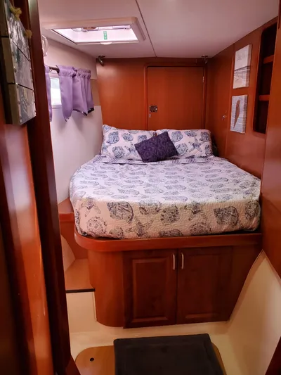  Yacht Photos Pics Cozy bedroom in 2011 Leopard 46 yacht with wood paneling and patterned bedding.