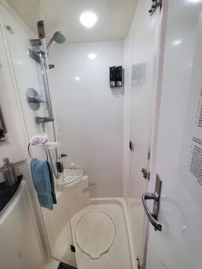  Yacht Photos Pics Compact bathroom in 2011 Leopard 46 yacht with shower, towel, and toiletries.