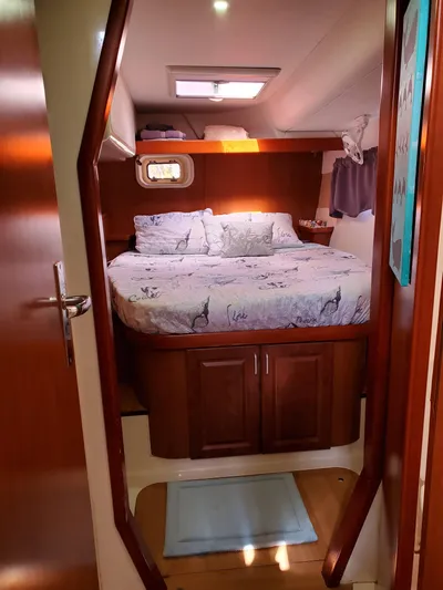  Yacht Photos Pics Cozy cabin interior of a 2011 Leopard 46 yacht with a neatly made bed.