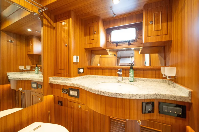 Northern Reign Yacht Photos Pics Luxurious bathroom interior of 2020 North Pacific 45 Pilothouse yacht with wood paneling.
