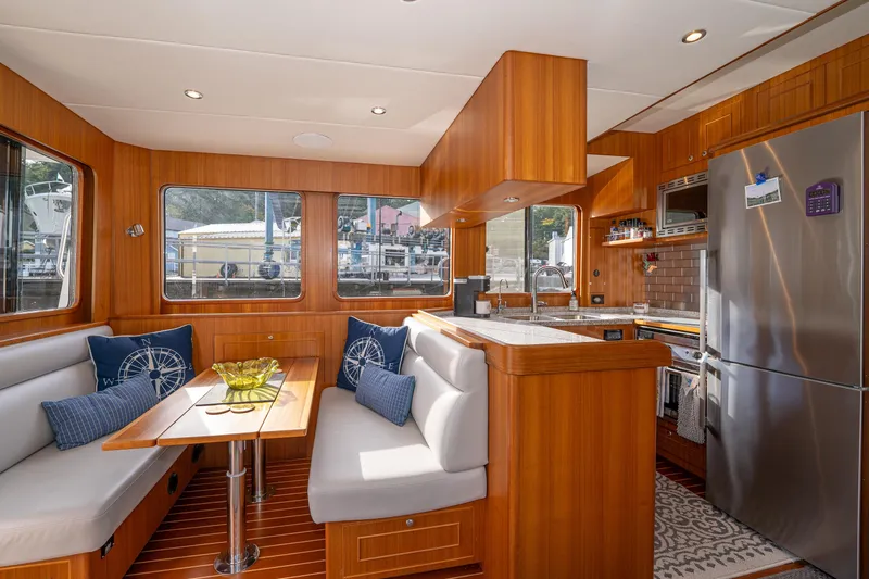 Northern Reign Yacht Photos Pics Interior of 2020 North Pacific 45 Pilothouse yacht with modern kitchen and dining area.