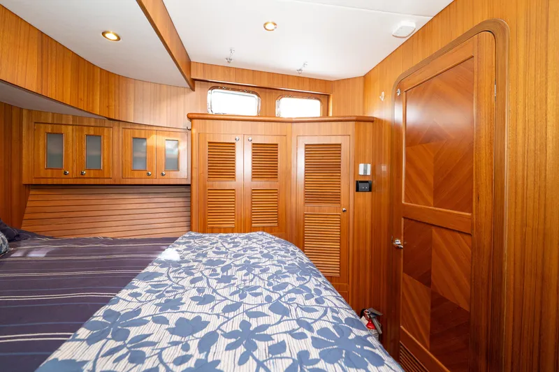 Northern Reign Yacht Photos Pics Luxurious wood-paneled bedroom in 2020 North Pacific 45 Pilothouse yacht.