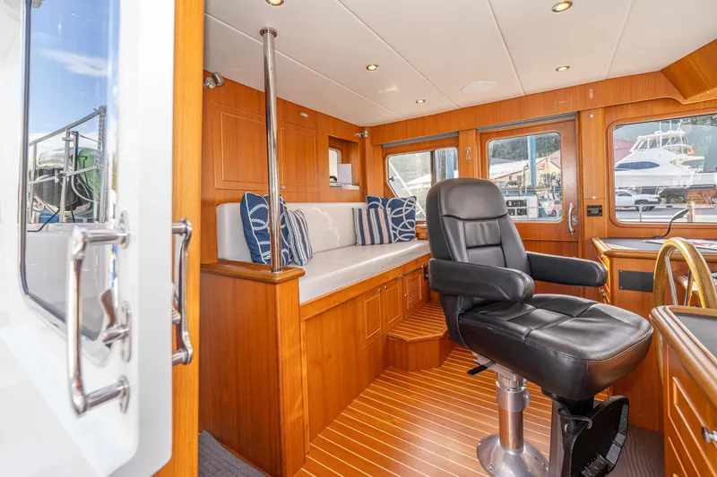 Northern Reign Yacht Photos Pics Interior of 2020 North Pacific 45 Pilothouse with leather chair and wooden accents.