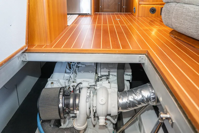 Northern Reign Yacht Photos Pics Engine compartment of 2020 North Pacific 45 Pilothouse with wooden flooring above.