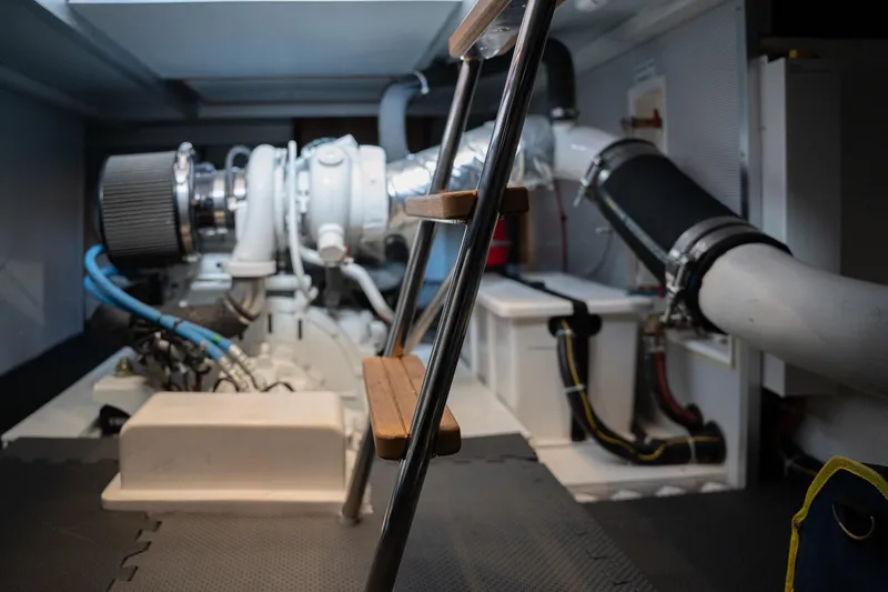 Northern Reign Yacht Photos Pics Engine room of 2020 North Pacific 45 Pilothouse yacht, featuring mechanical components and ladder.