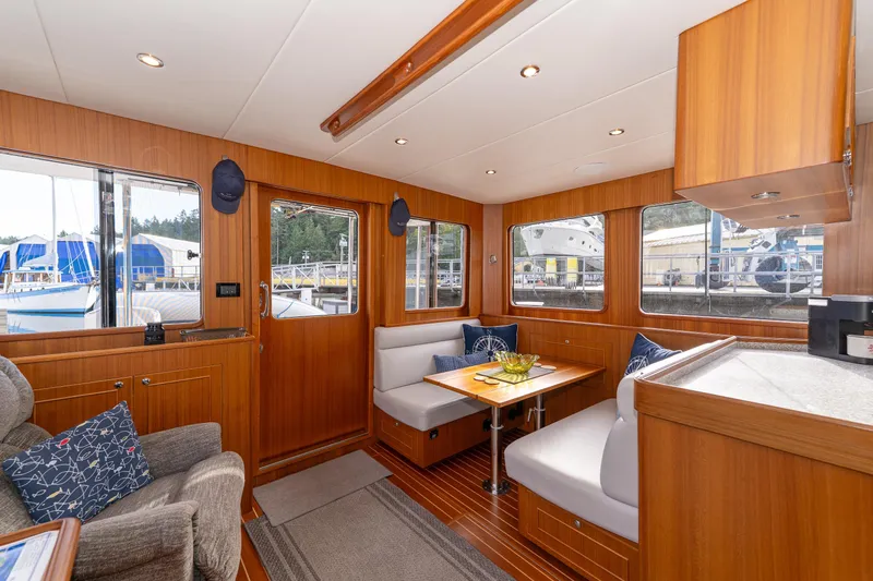 Northern Reign Yacht Photos Pics Luxurious interior of 2020 North Pacific 45 Pilothouse yacht with wood finish and seating area.