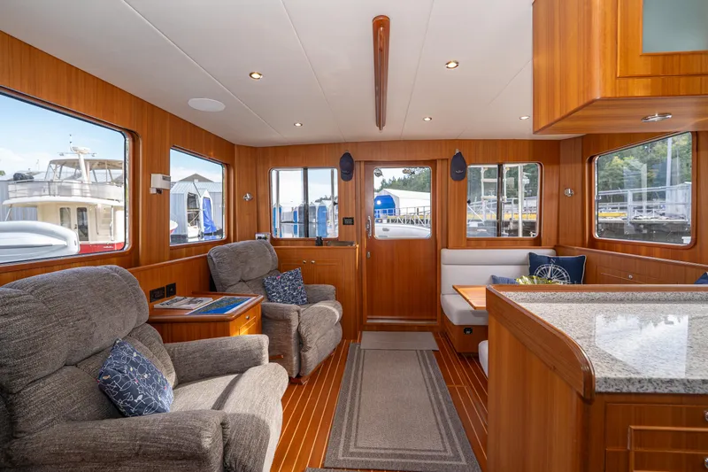 Northern Reign Yacht Photos Pics Luxurious interior of 2020 North Pacific 45 Pilothouse yacht with plush seating and wood finish.
