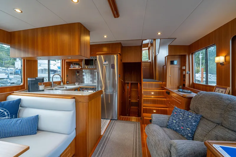 Northern Reign Yacht Photos Pics Luxurious interior of 2020 North Pacific 45 Pilothouse yacht with modern kitchen and cozy seating.