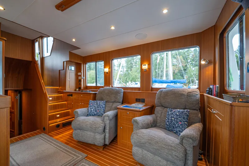 Northern Reign Yacht Photos Pics Luxurious interior of 2020 North Pacific 45 Pilothouse with plush seating and wood finish.