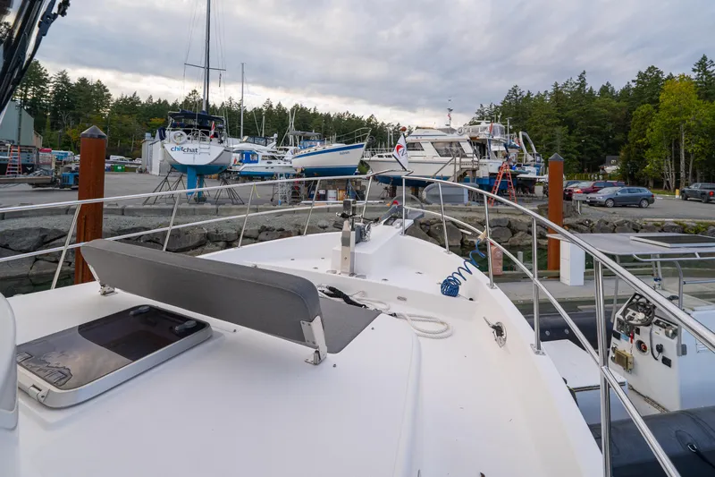 Northern Reign Yacht Photos Pics North Pacific 45 Pilothouse yacht docked at marina, surrounded by other boats and trees, 2020 model.