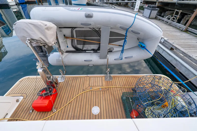 Northern Reign Yacht Photos Pics North Pacific 45 Pilothouse 2020 with dinghy and crab trap on deck.