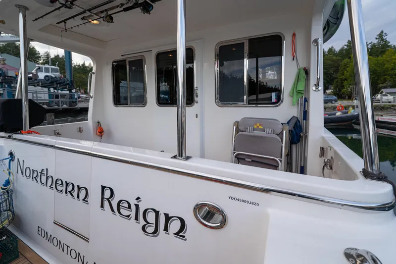 Northern Reign Yacht Photos Pics North Pacific 45 Pilothouse 2020 boat docked, featuring "Northern Reign" name on the side.