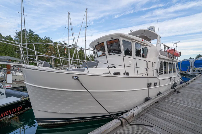 Northern Reign Yacht Photos Pics 2020 North Pacific 45 Pilothouse yacht docked at marina, showcasing sleek design.