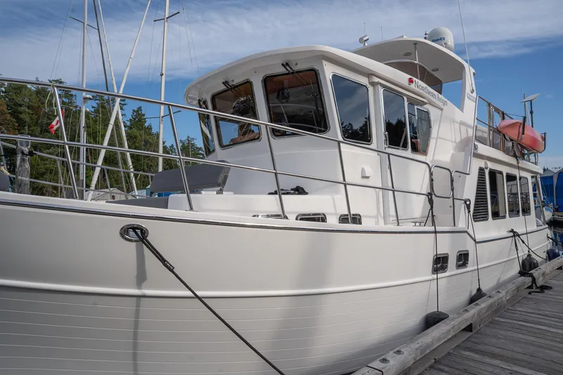 Northern Reign Yacht Photos Pics 2020 North Pacific 45 Pilothouse yacht docked at marina, side view.