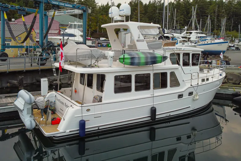Northern Reign Yacht Photos Pics 2020 North Pacific 45 Pilothouse yacht docked at marina with Canadian flag.