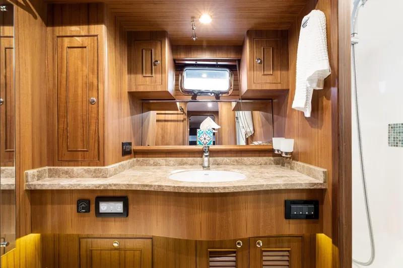 Northern Reign Yacht Photos Pics Luxurious wooden bathroom interior of 2020 North Pacific 45 Pilothouse yacht.