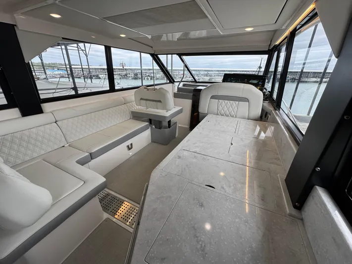  Yacht Photos Pics Luxurious interior of 2023 Regal 360 Grande Coupe yacht with elegant seating and panoramic windows.