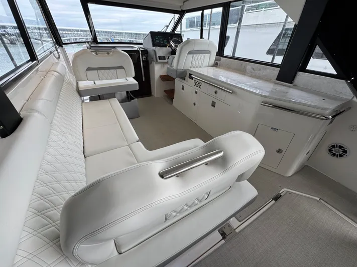  Yacht Photos Pics 2023 Regal 360 Grande Coupe interior with luxurious seating and modern helm.