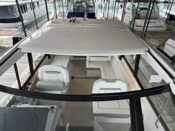  Yacht Photos Pics 2023 Regal 360 Grande Coupe interior with white seating, docked in a marina.