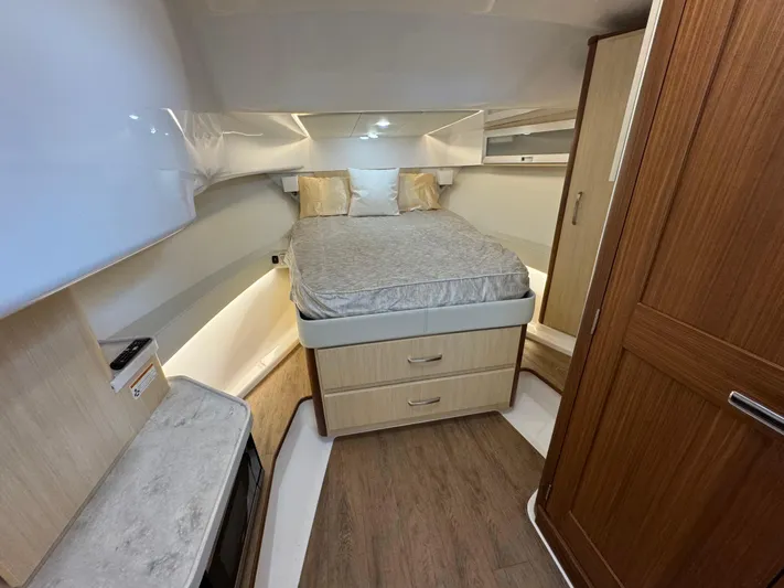  Yacht Photos Pics 2023 Regal 360 Grande Coupe interior cabin with bed, wood accents, and modern design.
