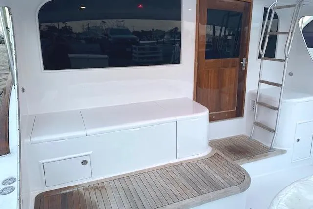 Swamp Fox Yacht Photos Pics 1989 Buddy Davis 61 Sportfish boat deck with seating and wooden door.