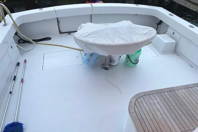 Swamp Fox Yacht Photos Pics 1989 Buddy Davis 61 Sportfish boat deck with fishing chair and cleaning supplies.