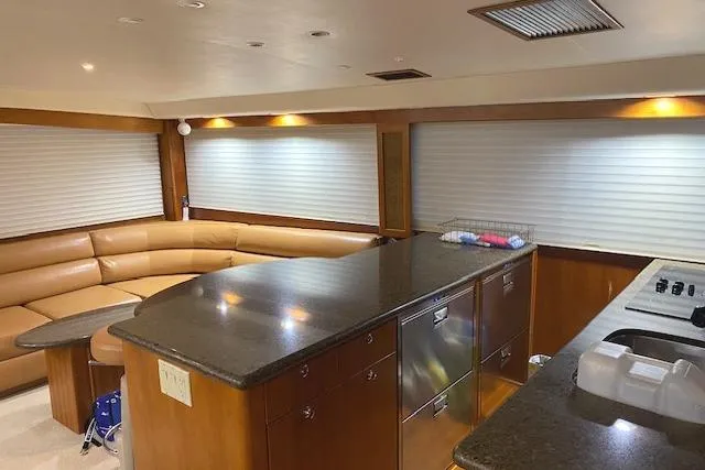 Swamp Fox Yacht Photos Pics Luxurious interior of 1989 Buddy Davis 61 Sportfish yacht with modern kitchen and seating area.