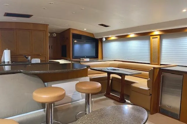 Swamp Fox Yacht Photos Pics Luxurious interior of 1989 Buddy Davis 61 Sportfish yacht with modern seating and entertainment area.