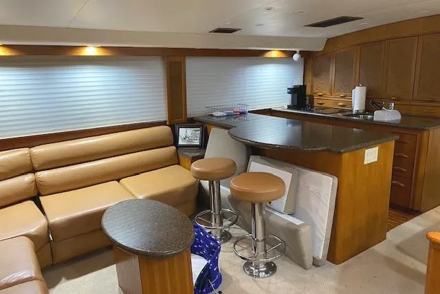 Swamp Fox Yacht Photos Pics Luxurious interior of a 1989 Buddy Davis 61 Sportfish yacht with leather seating and modern kitchen.