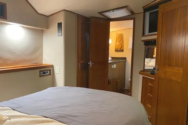 Swamp Fox Yacht Photos Pics Cozy cabin interior of 1989 Buddy Davis 61 Sportfish yacht with wooden furnishings.