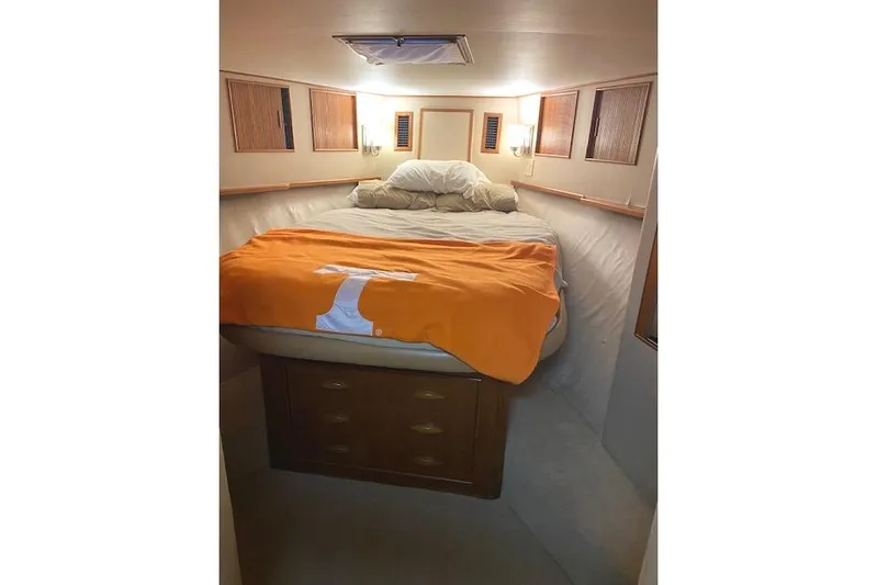 Swamp Fox Yacht Photos Pics Cozy cabin interior of 1989 Buddy Davis 61 Sportfish with bed and orange blanket.