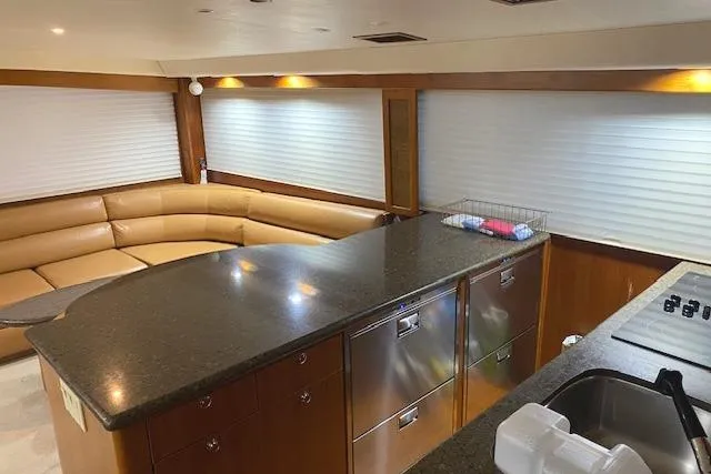 Swamp Fox Yacht Photos Pics Luxurious interior of 1989 Buddy Davis 61 Sportfish yacht with modern kitchen and seating area.