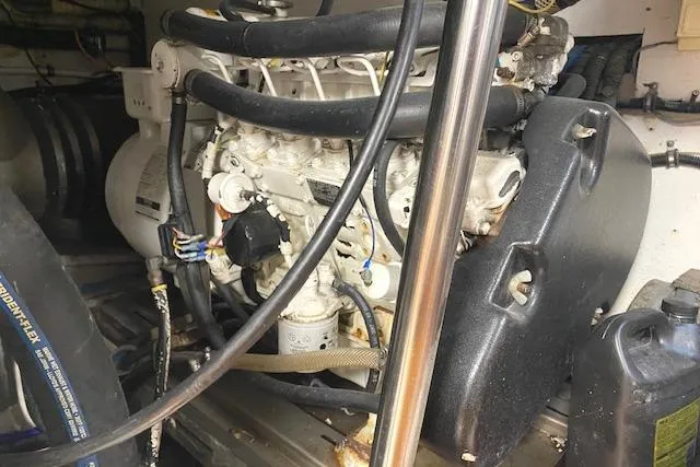 Swamp Fox Yacht Photos Pics Engine room of a 1989 Buddy Davis 61 Sportfish boat, showcasing mechanical components.