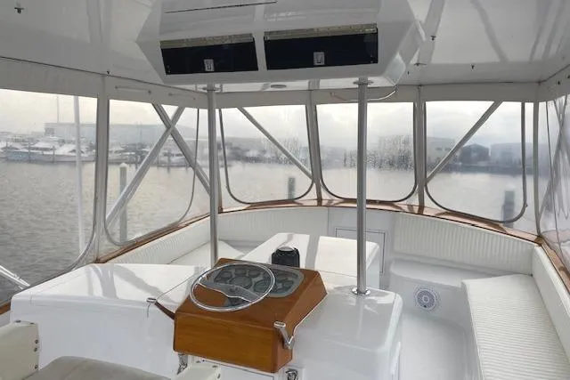 Swamp Fox Yacht Photos Pics 1989 Buddy Davis 61 Sportfish boat interior with helm, overlooking marina.