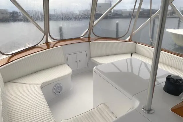 Swamp Fox Yacht Photos Pics 1989 Buddy Davis 61 Sportfish boat interior with white seating and table, docked at marina.