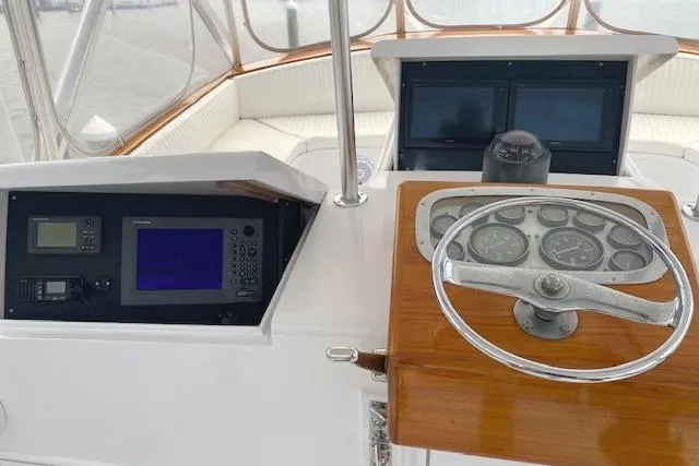 Swamp Fox Yacht Photos Pics Helm of 1989 Buddy Davis 61 Sportfish with navigation instruments and steering wheel.