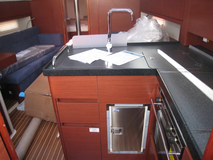 In Stock Yacht Photos Pics Interior of 2025 Hanse 348 yacht with modern kitchen and seating area.