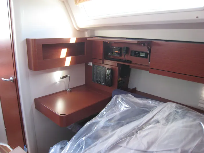In Stock Yacht Photos Pics Interior of 2025 Hanse 348 yacht with navigation equipment and wooden finish.