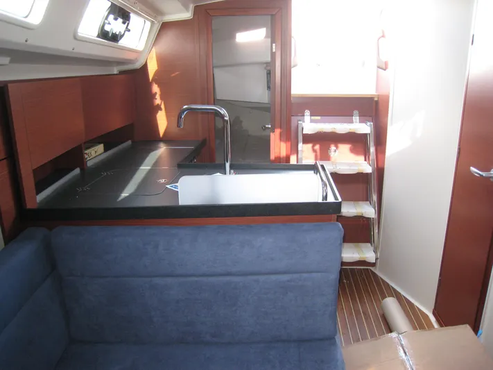 In Stock Yacht Photos Pics Interior of 2025 Hanse 348 yacht with modern kitchen and seating area.