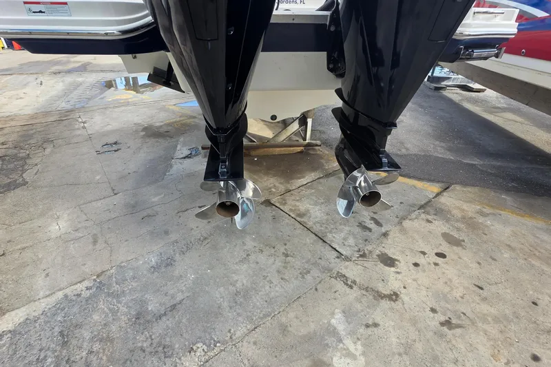  Yacht Photos Pics 2021 Sea Ray SDX 290 Outboard boat with dual propellers on a concrete surface.