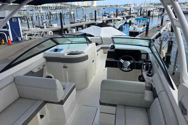  Yacht Photos Pics 2021 Sea Ray SDX 290 Outboard boat interior at marina, showcasing helm and seating area.
