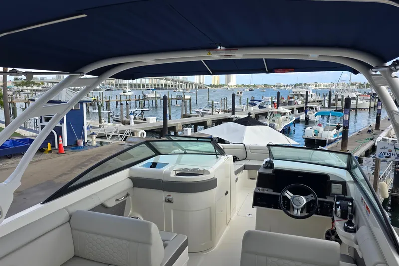  Yacht Photos Pics 2021 Sea Ray SDX 290 Outboard boat interior at marina, showcasing helm and seating area.