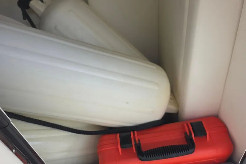  Yacht Photos Pics Storage compartment of 2021 Sea Ray SDX 290 Outboard with fenders and red toolbox.