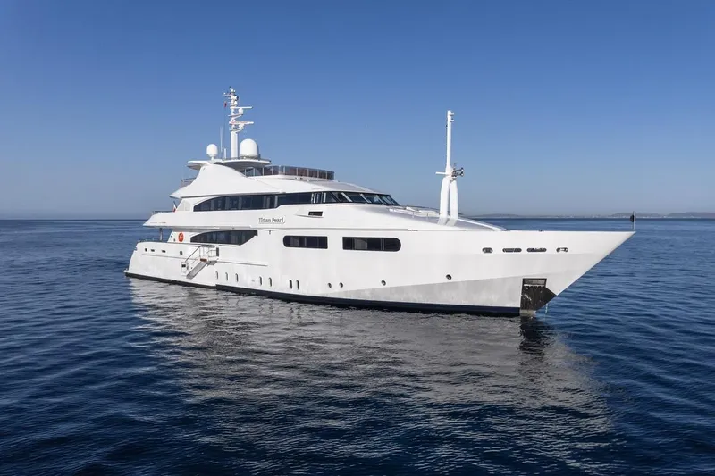 Titian Pearl Yacht Photos Pics Luxury yacht CRN Magnifica 2001 on calm sea under clear blue sky.